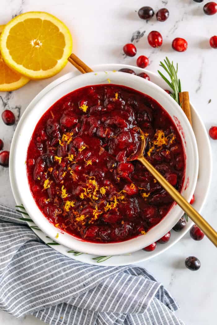 This Healthy Cranberry Sauce is naturally sweetened made with maple syrup, fresh orange juice, cinnamon, ginger and deep rich flavors from a little port wine. Sweet, tangy and the perfect addition to your Thanksgiving and Christmas table this season!