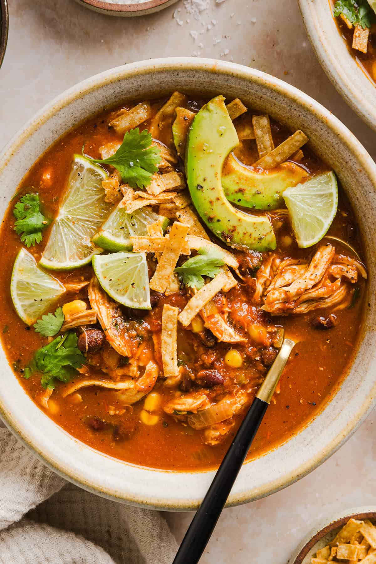 This Easy Chicken Tortilla Soup makes the perfect weeknight meal that can easily be made right in your instant pot, slow cooker or on the stove! Packed with tender shredded chicken, veggies, beans and all the toppings for a delicious, flavor-packed meal!