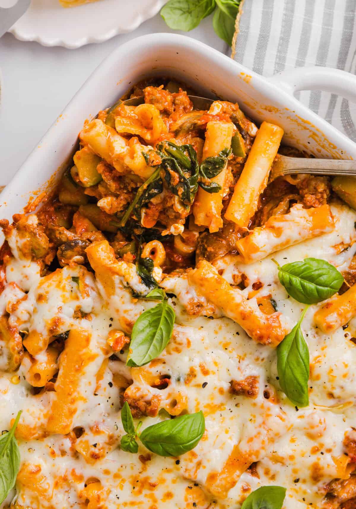 This comforting and delicious Healthy Baked Ziti recipe is packed with fresh veggies, flavorful turkey sausage and makes the perfect weeknight meal the whole family will love!  Leftovers are guaranteed!