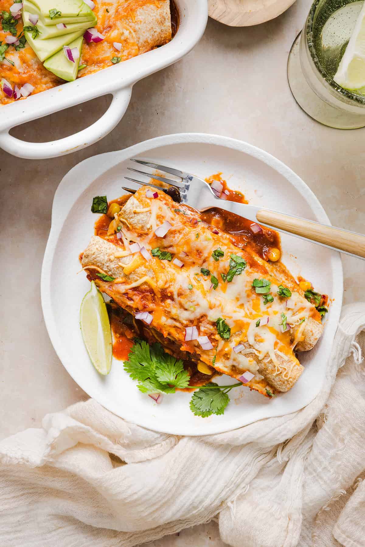 This Healthy Chicken Enchilada recipe is a family favorite made with wholesome, flavorful ingredients for the perfect weeknight meal! The homemade enchilada sauce tastes absolutely amazing!