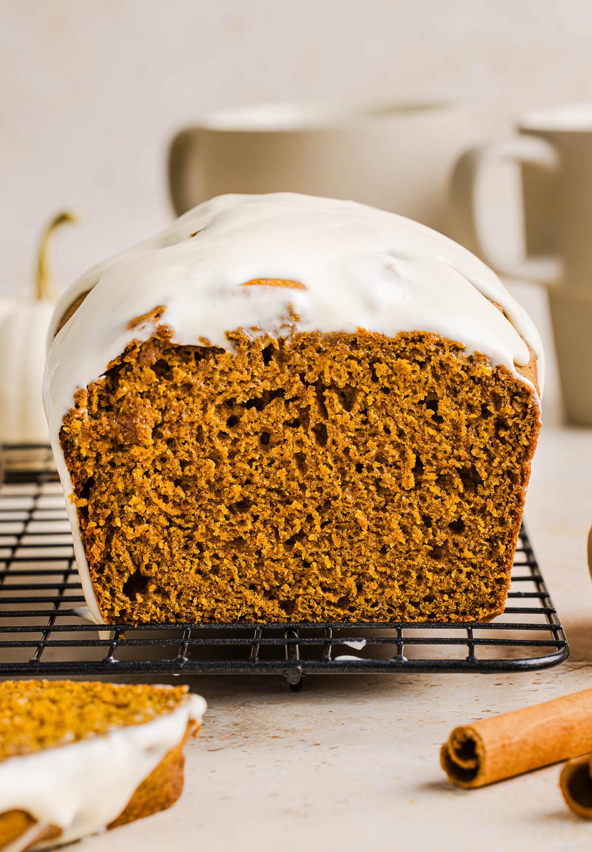 The BEST Healthy Pumpkin Bread that is moist, loaded with pumpkin flavor and made without any butter or refined sugar! Topped with a delicious maple cream cheese glaze for the perfect fall treat this season!